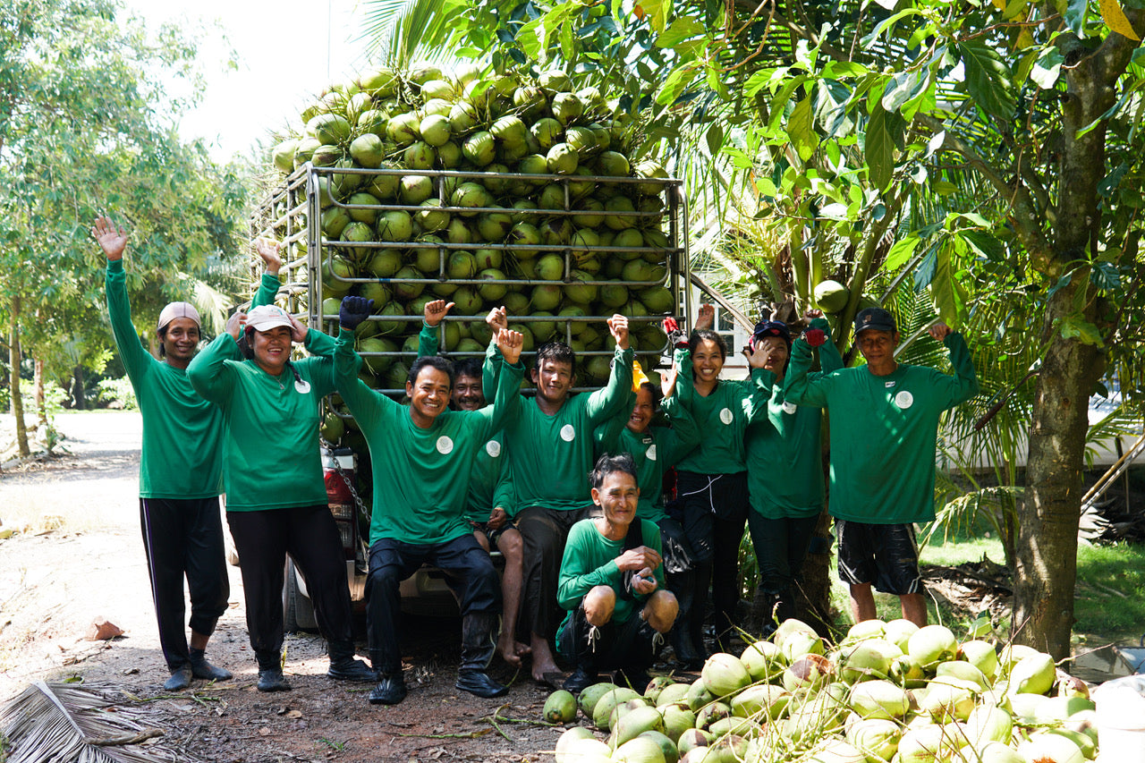 Copra Coconuts team celebrating after young Nam Ham coconuts harvest in Thailand.